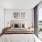 queen bed with side tables with lamps, painting above bed