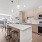 Model kitchen at our apartments for rent in Somerville, MA, featuring a kitchen island and a view of the living room.