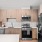 Model kitchen with stainless steel appliance and wood cabinets along with kitchen island