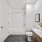 Model bathroom at our apartments for rent in Somerville, featuring tiled flooring and a shower / bath combo.