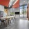 Resident lounge and co working space at our apartments in Somerville, featuring tiled flooring and a conference table.